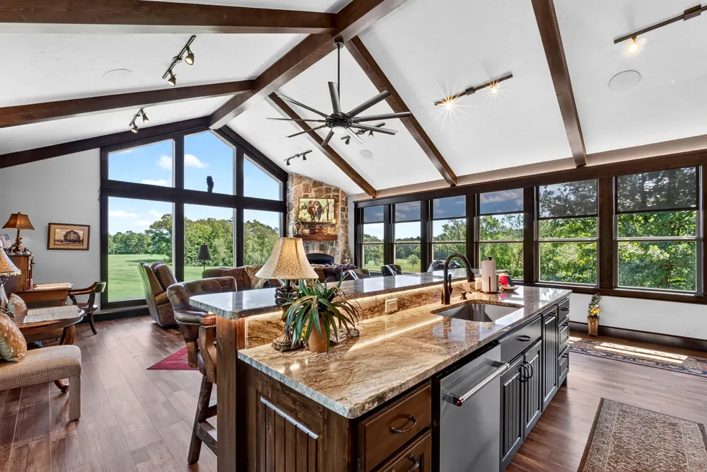 Vaulted living and kitchen space with expansive windows